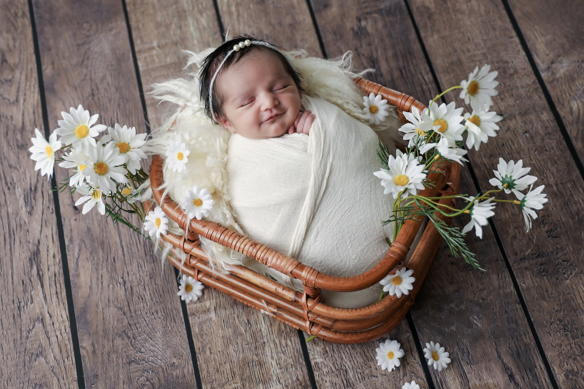 Newborn and daisy